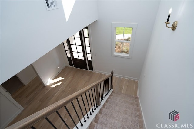 stairway with hardwood / wood-style floors