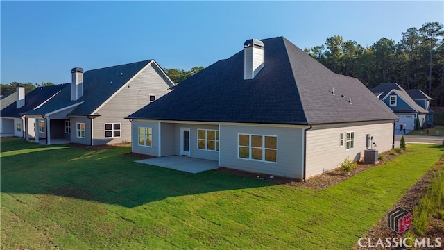 rear view of house featuring a yard, a patio, and central AC unit