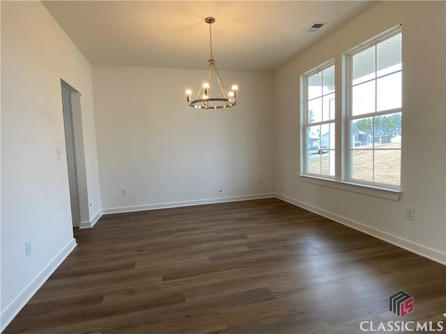 unfurnished room with dark hardwood / wood-style floors and a notable chandelier