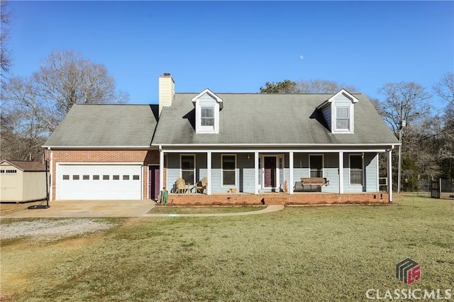 cape cod-style house with covered porch, a front yard, and a garage