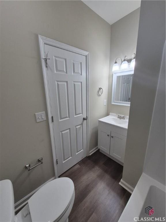 bathroom with vanity, toilet, and wood-type flooring