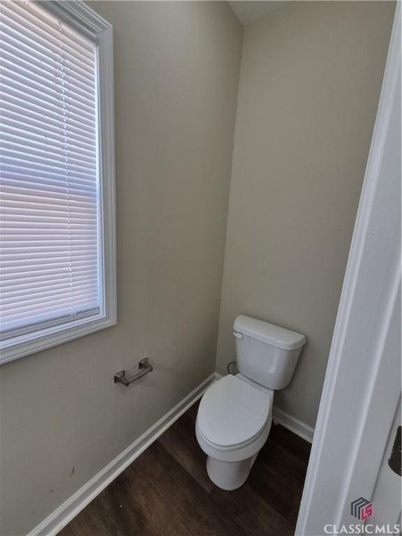 bathroom featuring hardwood / wood-style floors and toilet