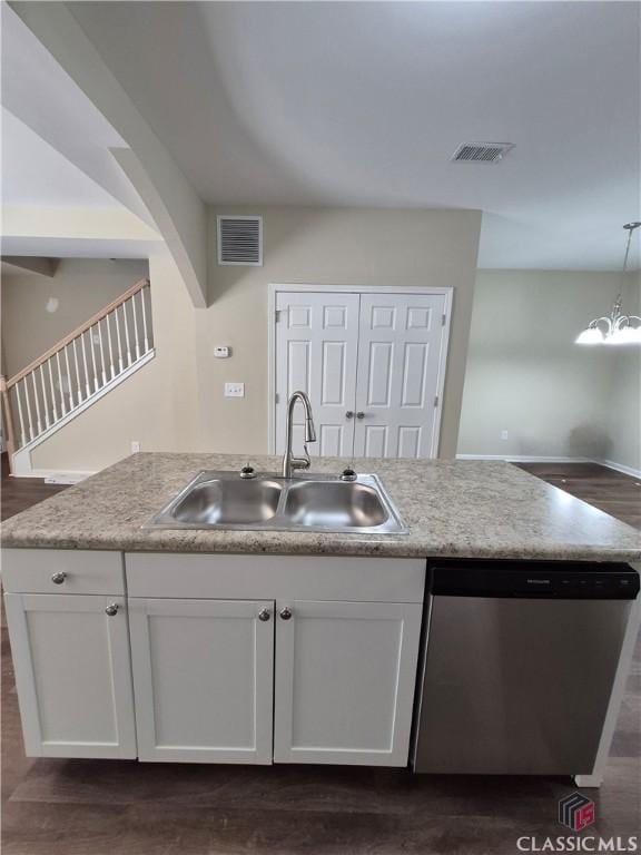 kitchen featuring white cabinetry, dishwasher, sink, dark wood-type flooring, and hanging light fixtures