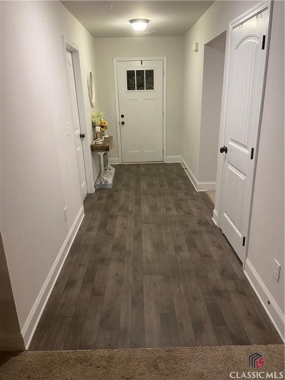 doorway with dark hardwood / wood-style flooring