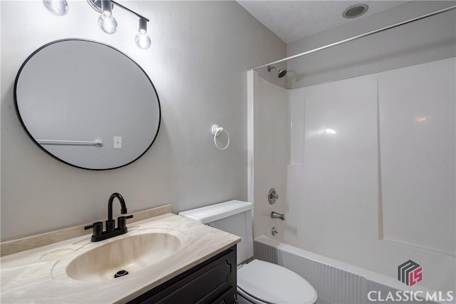 full bathroom with toilet, vanity, a textured ceiling, and tub / shower combination