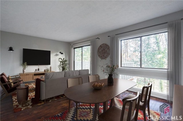 dining room with dark hardwood / wood-style flooring and a textured ceiling