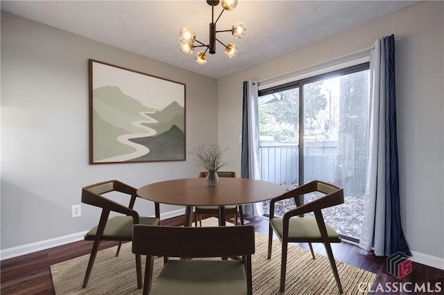 dining area with a textured ceiling, a chandelier, and dark hardwood / wood-style floors