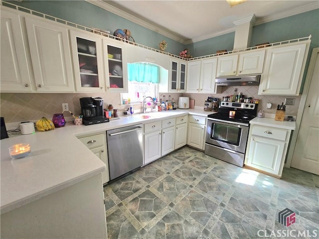 kitchen with under cabinet range hood, appliances with stainless steel finishes, decorative backsplash, and ornamental molding