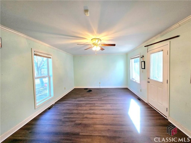 entryway with dark wood-style floors, ornamental molding, visible vents, and baseboards