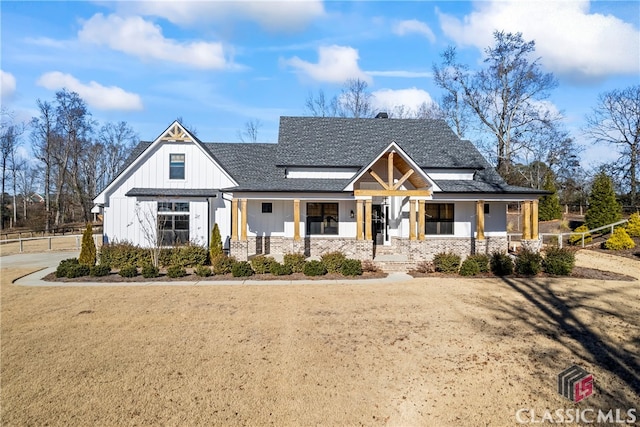 modern inspired farmhouse with covered porch and a front lawn