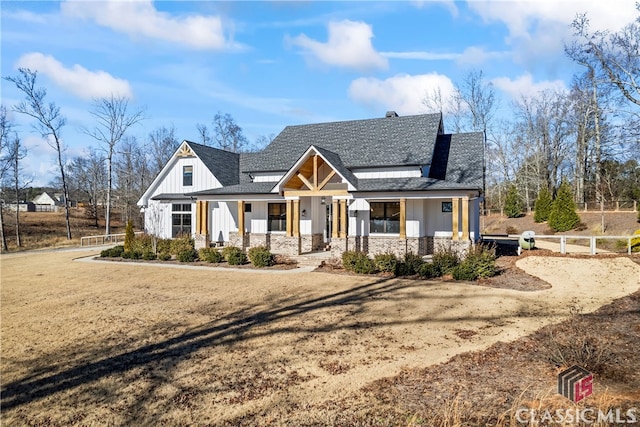 view of front of home with a front yard and covered porch