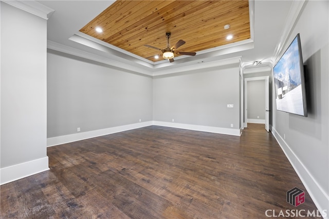 spare room with wood ceiling, a raised ceiling, crown molding, ceiling fan, and dark wood-type flooring