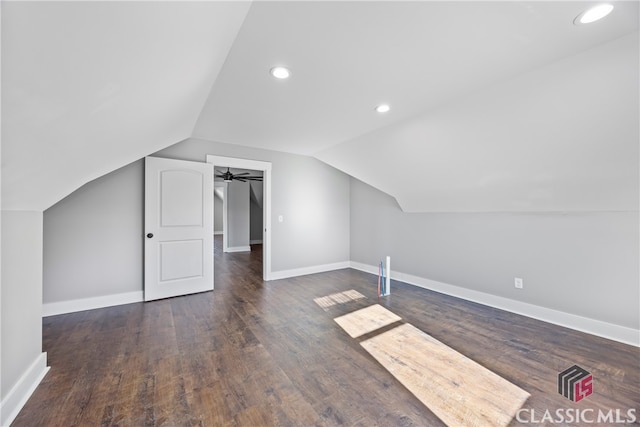 bonus room with ceiling fan, vaulted ceiling, and dark hardwood / wood-style flooring