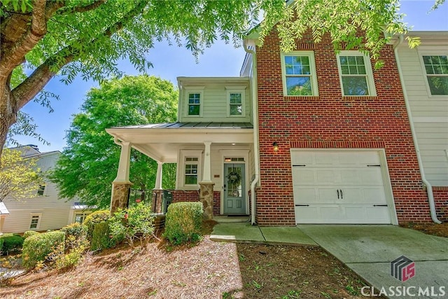 view of front of home with covered porch and a garage