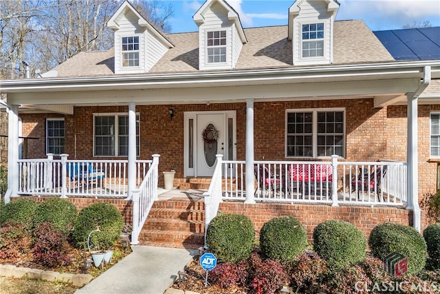 new england style home with covered porch