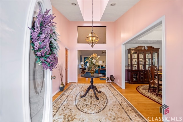 foyer entrance featuring a notable chandelier and light hardwood / wood-style flooring