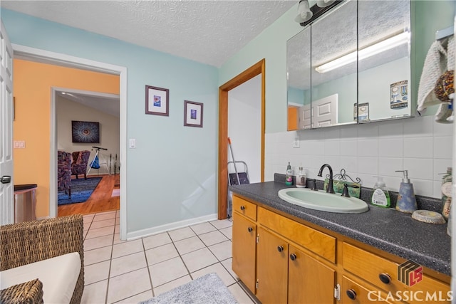 bathroom featuring a textured ceiling, vanity, tile patterned floors, and decorative backsplash