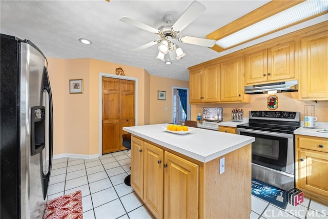 kitchen featuring a kitchen island, ceiling fan, light tile patterned floors, and appliances with stainless steel finishes