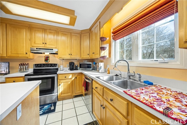 kitchen with appliances with stainless steel finishes, light tile patterned flooring, and sink