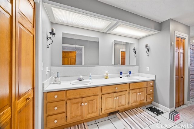 bathroom with tile patterned flooring and vanity