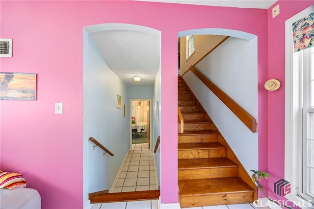 stairs featuring tile patterned flooring