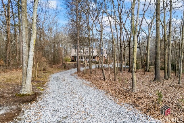 new england style home with covered porch and solar panels