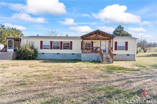 manufactured / mobile home featuring a porch and a front lawn