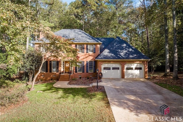 view of front of house with a front yard and a garage