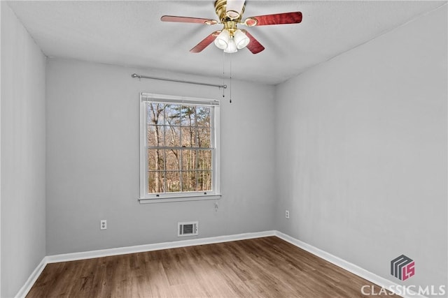 spare room with ceiling fan and hardwood / wood-style floors