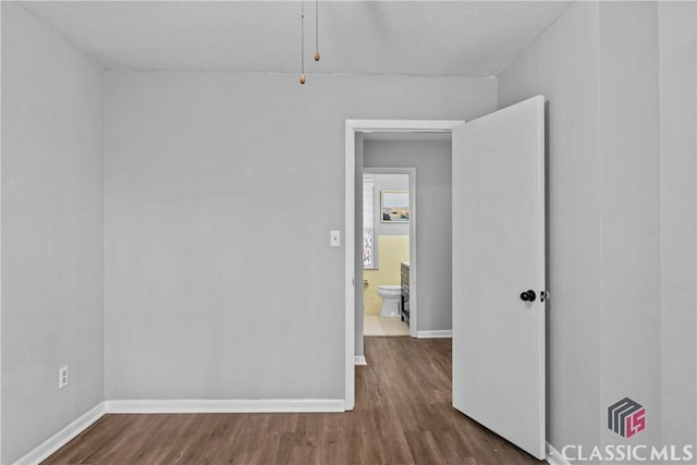 unfurnished room with hardwood / wood-style flooring