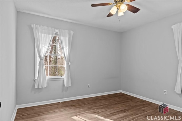 spare room with ceiling fan and wood-type flooring