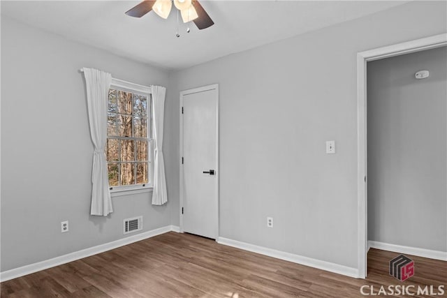 unfurnished bedroom with ceiling fan and wood-type flooring