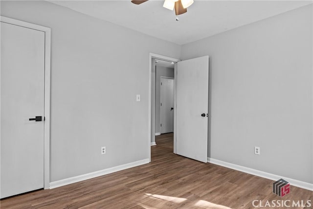 unfurnished bedroom featuring ceiling fan and hardwood / wood-style flooring