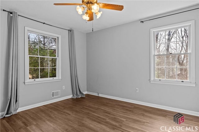 spare room with ceiling fan and dark hardwood / wood-style floors