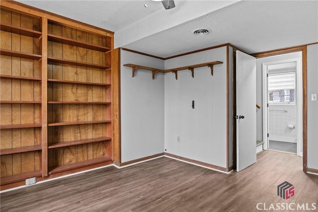 unfurnished bedroom featuring wood-type flooring and a textured ceiling