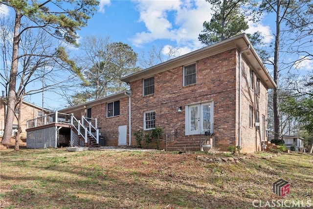 rear view of property with a lawn and a deck