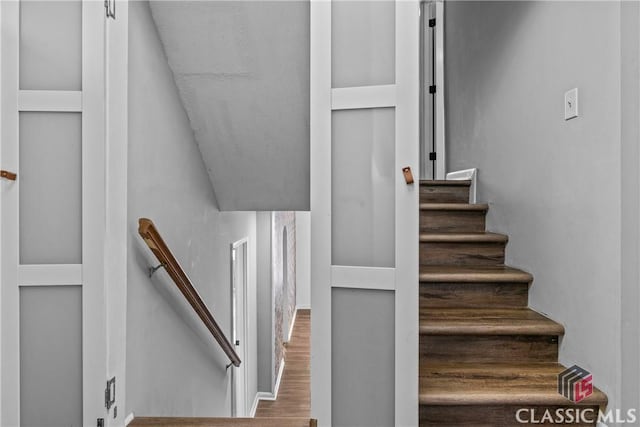 stairs with wood-type flooring