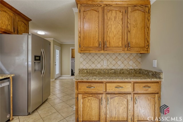 kitchen featuring stainless steel appliances, a textured ceiling, light tile patterned floors, tasteful backsplash, and crown molding