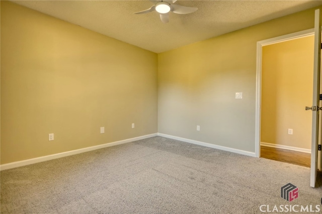 carpeted empty room featuring ceiling fan and a textured ceiling