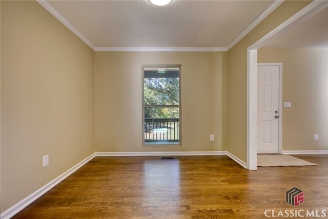 unfurnished room featuring a textured ceiling, crown molding, and dark wood-type flooring