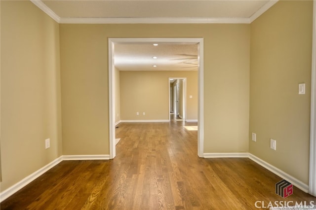 spare room featuring ornamental molding and hardwood / wood-style flooring