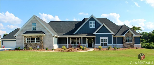 craftsman-style house featuring a garage and a front yard