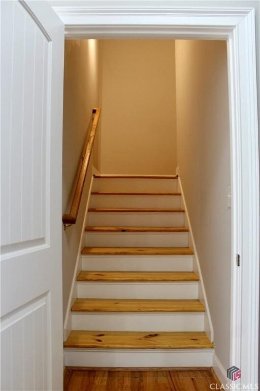 stairs with hardwood / wood-style flooring