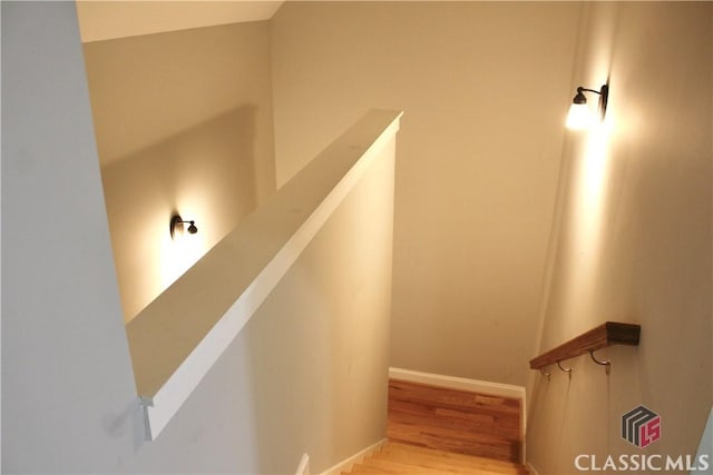 stairs featuring hardwood / wood-style flooring