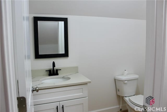 bathroom with toilet and vanity