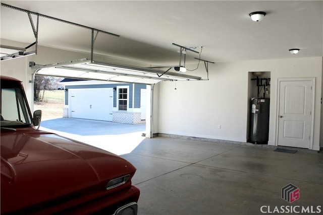 garage featuring a garage door opener, electric water heater, and a carport