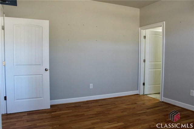 empty room featuring dark hardwood / wood-style flooring