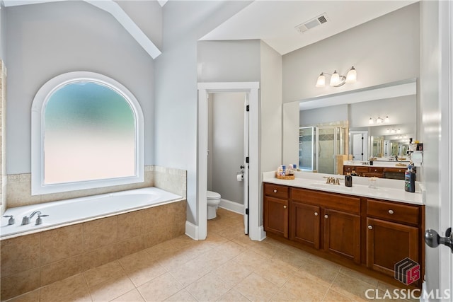 full bathroom featuring toilet, tile patterned flooring, vaulted ceiling, shower with separate bathtub, and vanity