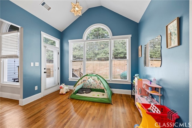 game room featuring vaulted ceiling and hardwood / wood-style flooring