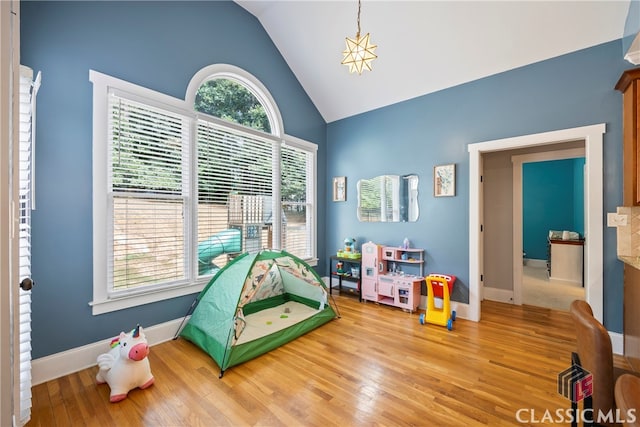 playroom with vaulted ceiling and hardwood / wood-style floors